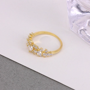Macro shot of gold wedding ring with clustered diamonds and a large center stone