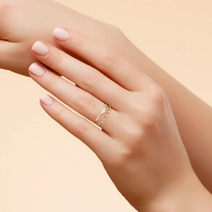 Macro detail of two minimalist gold S925 silver rings with kite-cut zircon stones