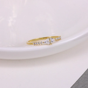 Macro view of golden S925 silver ring featuring geometric triangle cut zircons