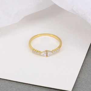 Close-up of geometric S925 silver ring with triangular and round zircons on white card