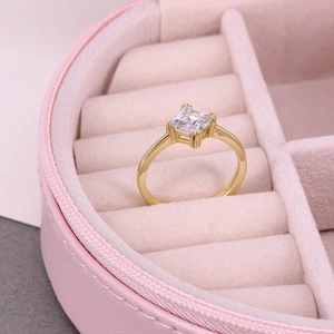 Close-up of S925 sterling silver gold ring with square cubic zirconia in pink velvet box