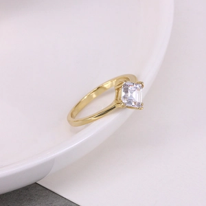 Detail of s925 silver ring featuring a square cut zircon in a classic four-prong gold setting