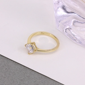 Macro shot of S925 sterling silver gold-plated ring with emerald-cut zircon stone
