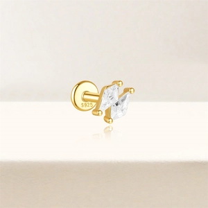 Detailed macro of S925 sterling silver stamp on golden labret stud with zircons