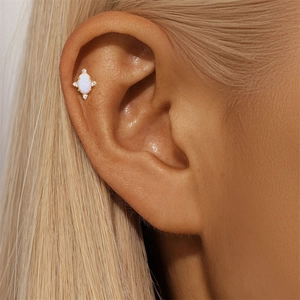 Detail of s925 silver stud with opal and zircons on the upper ear cartilage