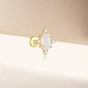 Macro detail of gold S925 sterling silver ear stud with opal and white zirconia inlay
