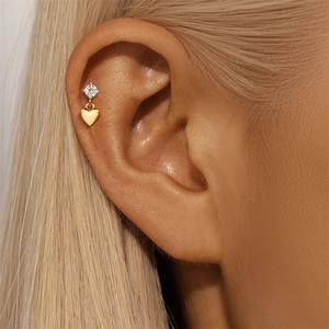 Detail of s925 silver heart stud with round zircon and gold heart drop on ear cartilage