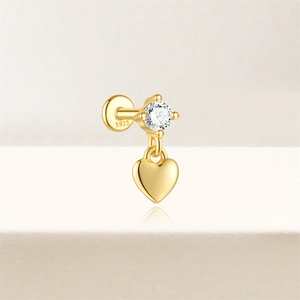 Detail of 16G gold-plated S925 silver stud with cubic zirconia and heart pendant