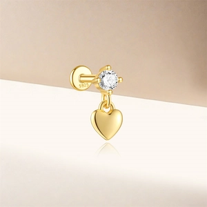 Macro view of S925 sterling silver gold heart stud earring with cubic zirconia inlay