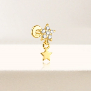 Detail of S925 sterling silver gold-plated star stud earring with sparkling crystals