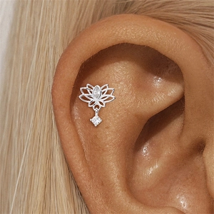 Detailed shot of silver lotus stud earring with opal and marquise zircon on ear