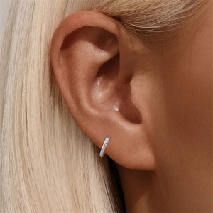 Close-up of minimalist s925 silver hoop earring with small sparkling pavé crystals
