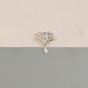Macro detail of silver lotus pendant with marquise opal stone and zircon tassel dangle