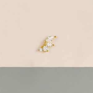 Macro view of gold stud earring featuring marquise and round cut cubic zirconia stones