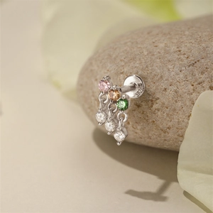 Detailed macro shot of S925 sterling silver earring with colorful gems and tassels