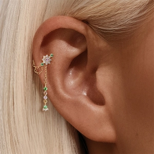 Detail of s925 silver flower cartilage stud with pink zircons and layered gold chains