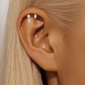 Close-up of pink marquise opal stud earrings with gold plating on model ear