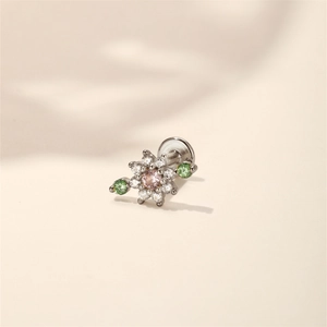 Macro view of a silver floral labret stud featuring pink and green crystals and white stones