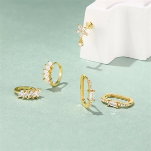 Detailed macro view of S925 gold earrings with marquise cut stones and cubic zirconia