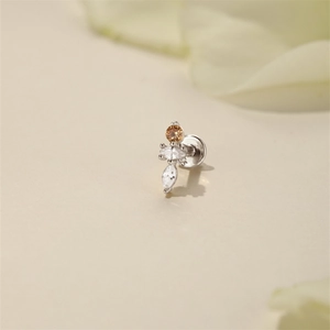 Macro detail of s925 silver stud with amber round gem and marquise zirconia stones