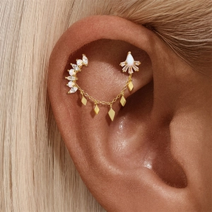 Detailed view of gold chain ear cuff with white opal and sparkling diamond accents