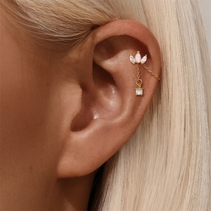 Detail of 18K gold crown earring with teardrop opal, clear zircon, and dangling chain