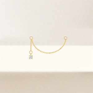 Detailed close-up of a gold star and heart ear chain with sparkling cubic zirconia charms