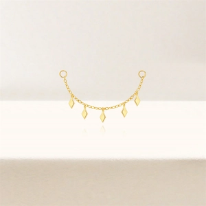 Detail of gold rhombus chain earring drop showing five polished geometric metal charms