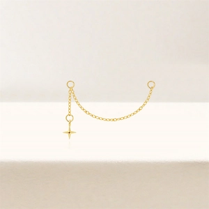 Detailed view of a gold plated star pendant chain accessory for piercing earrings