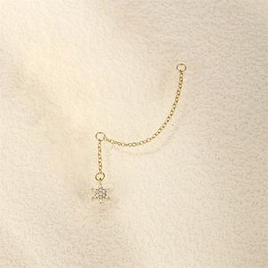 Macro shot of gold S925 sterling silver chain earrings with hexagram star pendant