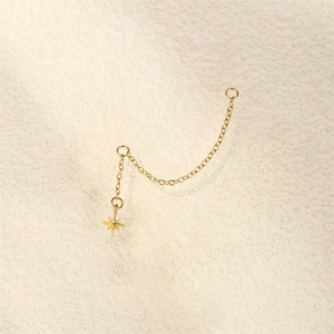 Detailed close-up of gold star pendant and delicate chain accessory for earring DIY