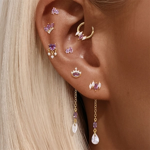 Detailed close-up of S925 silver piercing earrings with amethyst and zircon on an ear