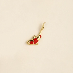 Detailaufnahme einer goldenen Koi-Fisch-Brosche mit roter Emaille und funkelndem Stein