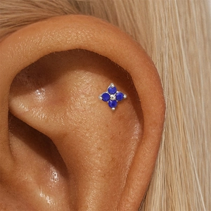 Macro view of S925 silver flat piercing stud with blue lapis lazuli clover design