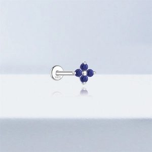 Detailed macro shot of S925 silver stud earring with blue lapis lazuli clover design