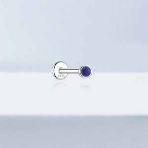 Macro detail of S925 sterling silver flat back stud earring with round blue lapis stone