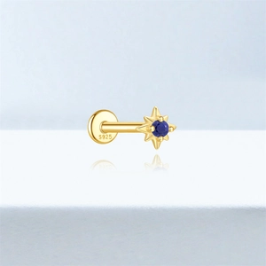 Macro view of S925 sterling silver gold stud with starburst blue lapis lazuli stone