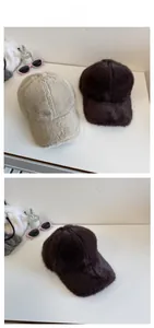 Detail view of plush winter baseball caps in beige and coffee colors with soft fur texture
