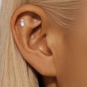 Detail of s925 silver ear piercing featuring round and teardrop natural moonstones