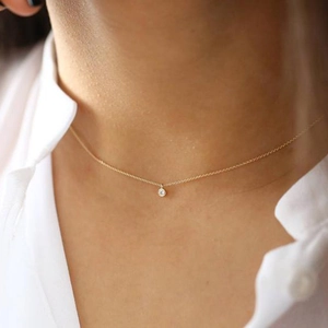 Detailed view of a minimalist S925 silver gold-plated solitaire necklace on a neck