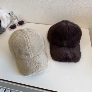 Winter plush faux fur baseball caps in beige and dark brown with a soft warm texture