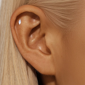 Macro shot of s925 silver marquise moonstone stud earring worn on the helix piercing