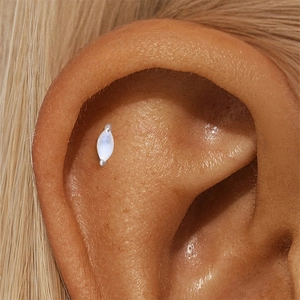 Close-up of s925 silver marquise moonstone stud earring on ear scapha piercing