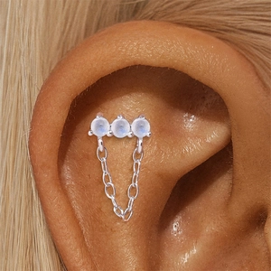 Detailed view of s925 silver cartilage stud featuring moonstone and dangling chain
