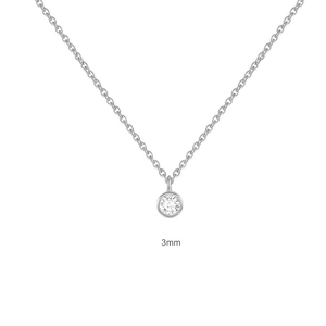 Detail shot of a 3mm round solitaire pendant in bezel setting on a silver chain necklace