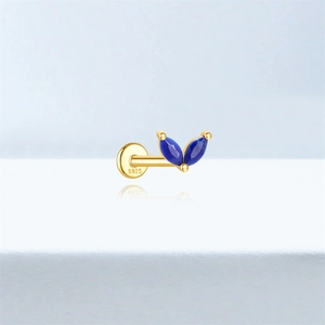 Macro shot of S925 stamped gold flat back stud with blue marquise-cut clover stones