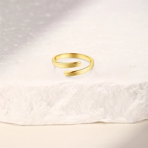 Close-up of golden S925 sterling silver wave ring showing hallmark and texture