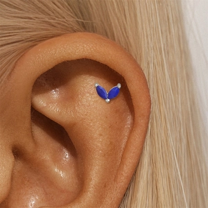 Close-up of a s925 silver ear stud with navy blue clover marquise stones on ear