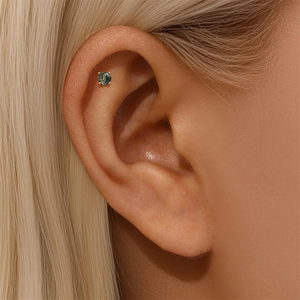 Close-up of s925 silver gold-plated earring with natural green moss agate in four-prong setting
