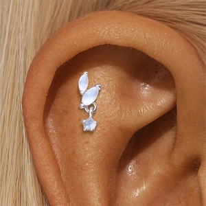 Close-up of s925 silver stud earring featuring three moonstones and a star pendant charm
